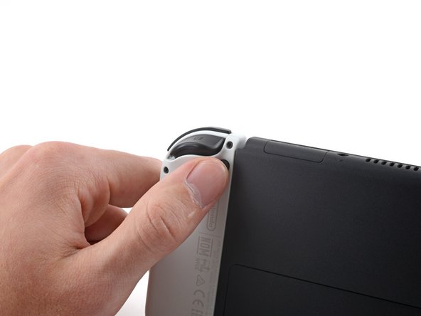 Шаг 1: Освободи фиксаторы Joy-Con, фото 1