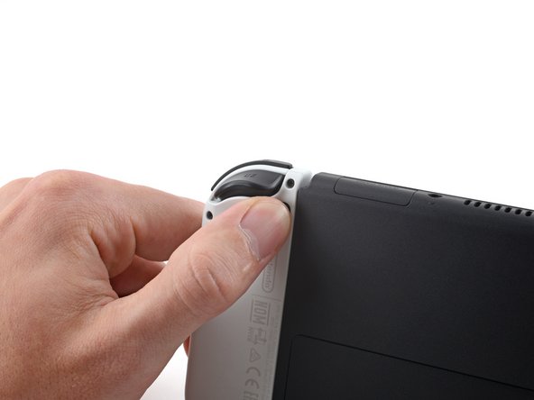 Шаг 1: Освободи фиксаторы Joy-Con, фото 2